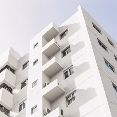 low-angle-shot-facade-white-modern-building-blue-clear-sky